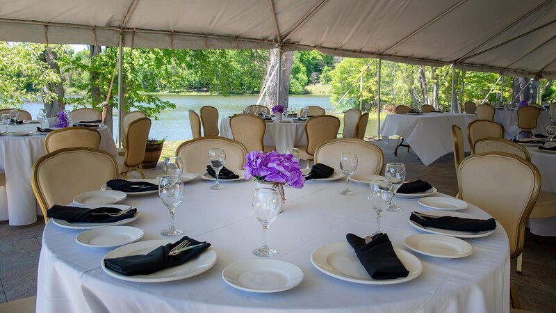 Round table under tent set for eight