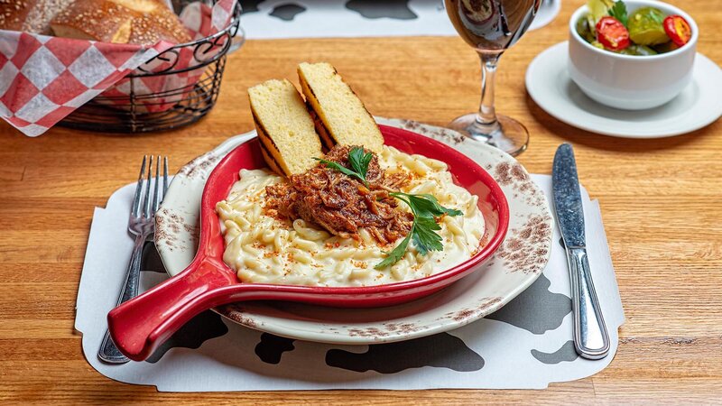 Mac and cheese topped with pulled pork