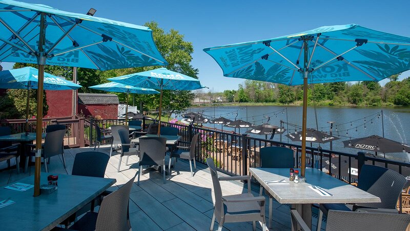 Blue umbrellas at tables in outdoor dining area