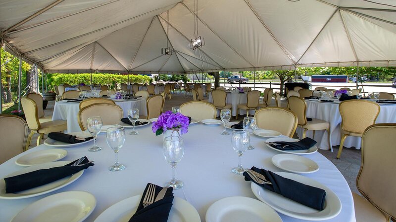 Tent area with tables set for private event