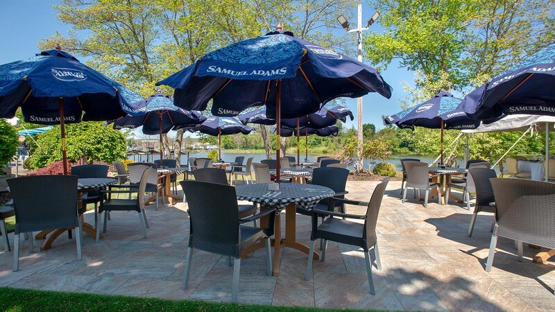 Outdoor patio dining area with tables and blue umbrellas